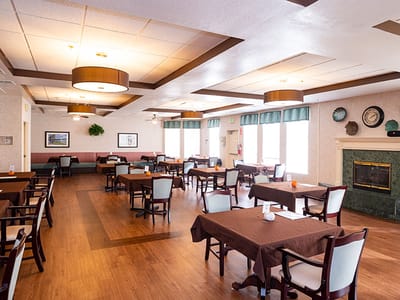 Dining area with tables and chairs in a bright room