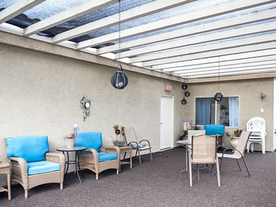 Outdoor seating area with blue chairs and plants