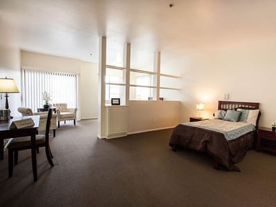 Spacious resident room with a bed and seating area