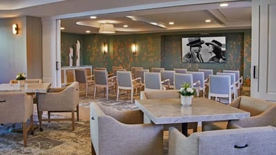 Bright common area with seating and a movie screen