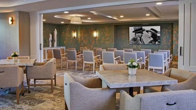 Common area with seating and a large screen