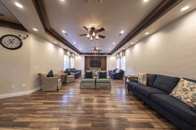 Bright common area with seating and ceiling fans
