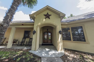 Entrance of Valiente Senior Living facility showing rocking chairs