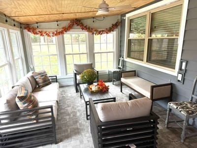 Cozy sunroom area with comfortable seating and decor