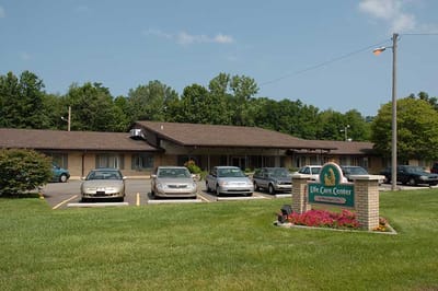 Exterior view of Life Care Center with parking and landscaping