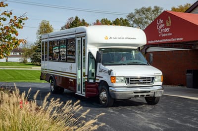 Facility transport van parked outside the entrance