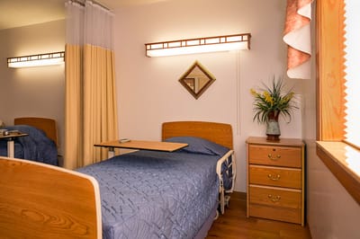 A private resident room with bed and personal items
