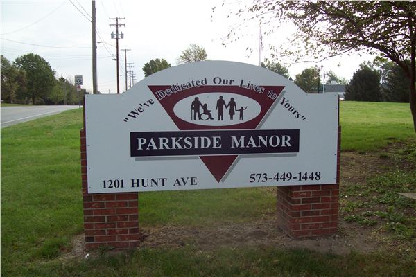 Sign for Parkside Manor with logo and contact information
