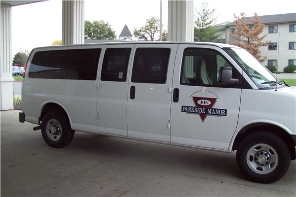Facility transport van parked at entrance