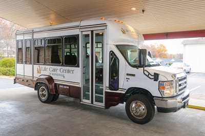 Facility transport van parked outside the building