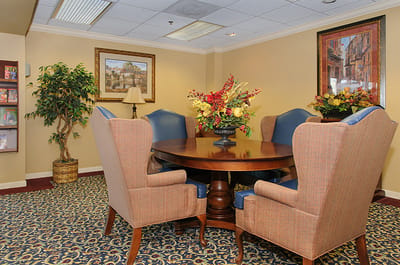 Cozy interior sitting area with comfortable chairs and decorative flowers