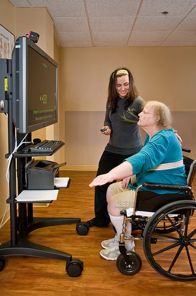 Staff member assisting resident with therapy activities