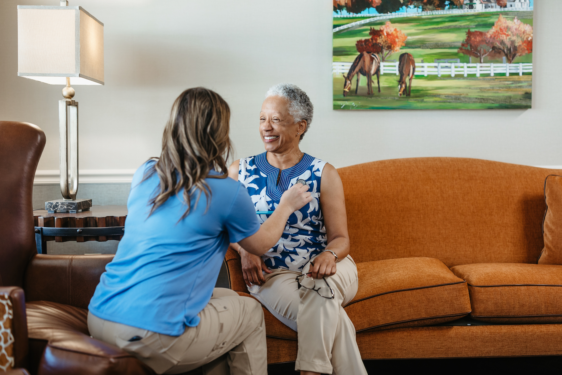 Staff assisting a resident in a common area
