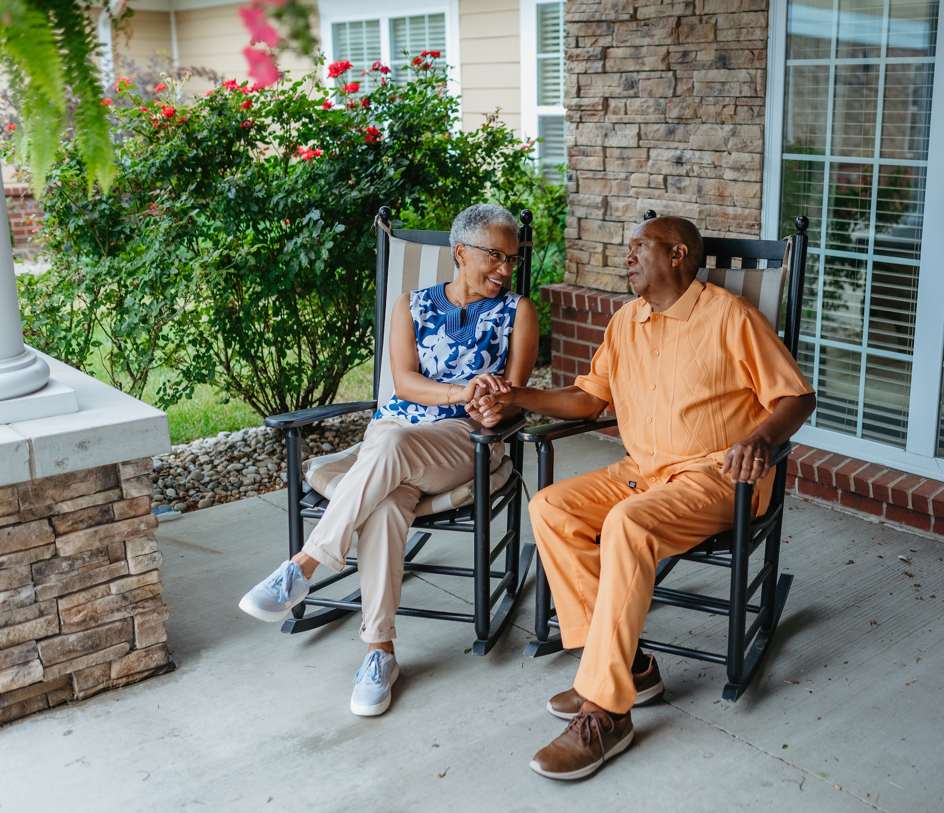 Two residents enjoying a conversation on a porch