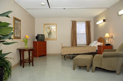 Comfortable resident room with bed and chair