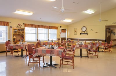 A bright dining room with tables set for meals