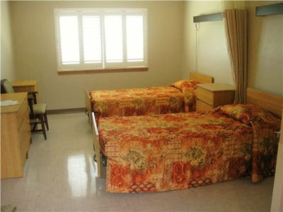 Private resident room with two beds and furniture