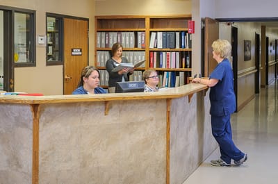 Staff assisting visitors at the reception area