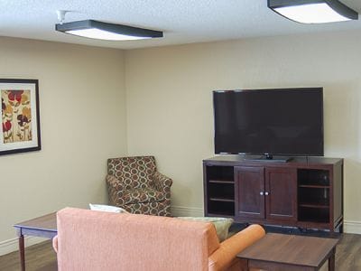 Interior common area with seating and TV