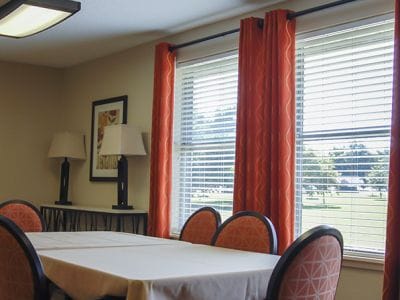 Bright common area with large windows and seating