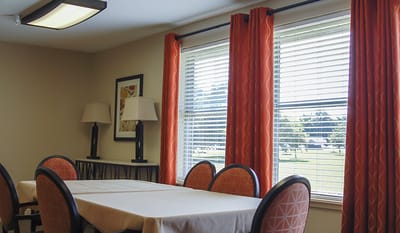 Bright common area with large windows and a table