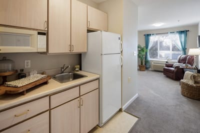 Interior of a resident room with kitchenette and lounge area
