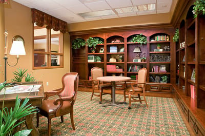 Brightly lit common area with bookshelves and seating