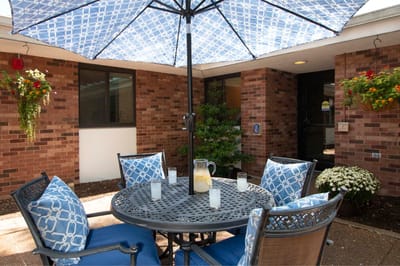 Outdoor seating area with a table and umbrellas