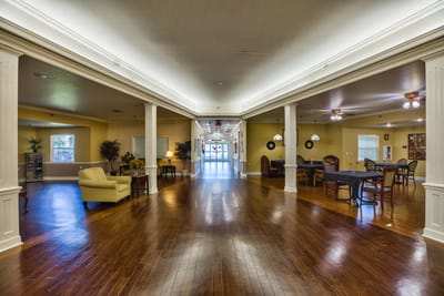 Bright common area with seating and wooden floors