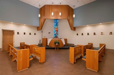 Interior view of a chapel with wooden benches