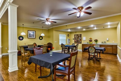 Dining area with dark tables and flower centerpieces