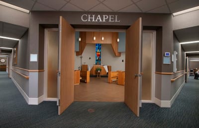 Interior view of a chapel with wooden doors