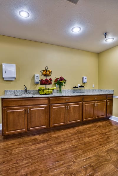 Kitchen area with fruit display and flowers