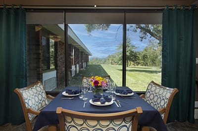 Dining room table with a view of the outdoor space