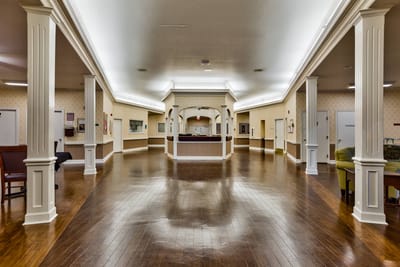 Interior hallway with wooden flooring and pillars