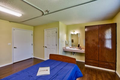 Bright and spacious resident room with wooden furniture