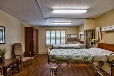 Comfortable twin beds in a cozy resident room