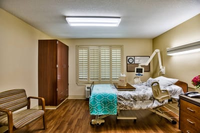 Private room with hospital bed and furniture