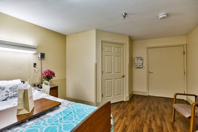 Comfortable resident room with a bed and chair