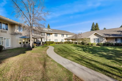 Well-maintained garden and walking path in a senior living facility