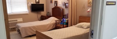A resident room with two single beds and personal decor