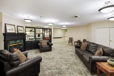 Cozy common area with leather sofas and a fireplace