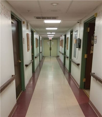 Well-lit corridor in a senior living facility
