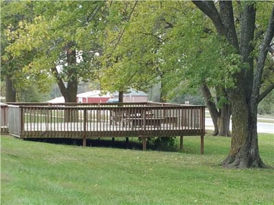 Wooden deck surrounded by trees in outdoor space
