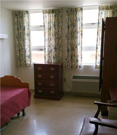 Private resident room with a bed and dresser