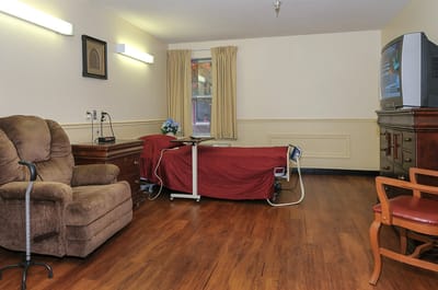 Cozy resident room with furniture and TV