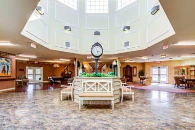 Bright common area with large clock and seating