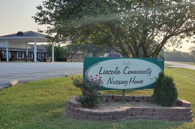 Sign for Lincoln Community Nursing Home with facility in background
