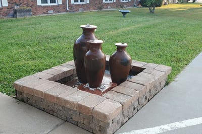 Outdoor water fountain surrounded by grass