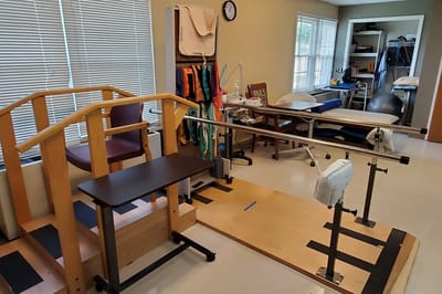 A physical therapy room with equipment for rehabilitation